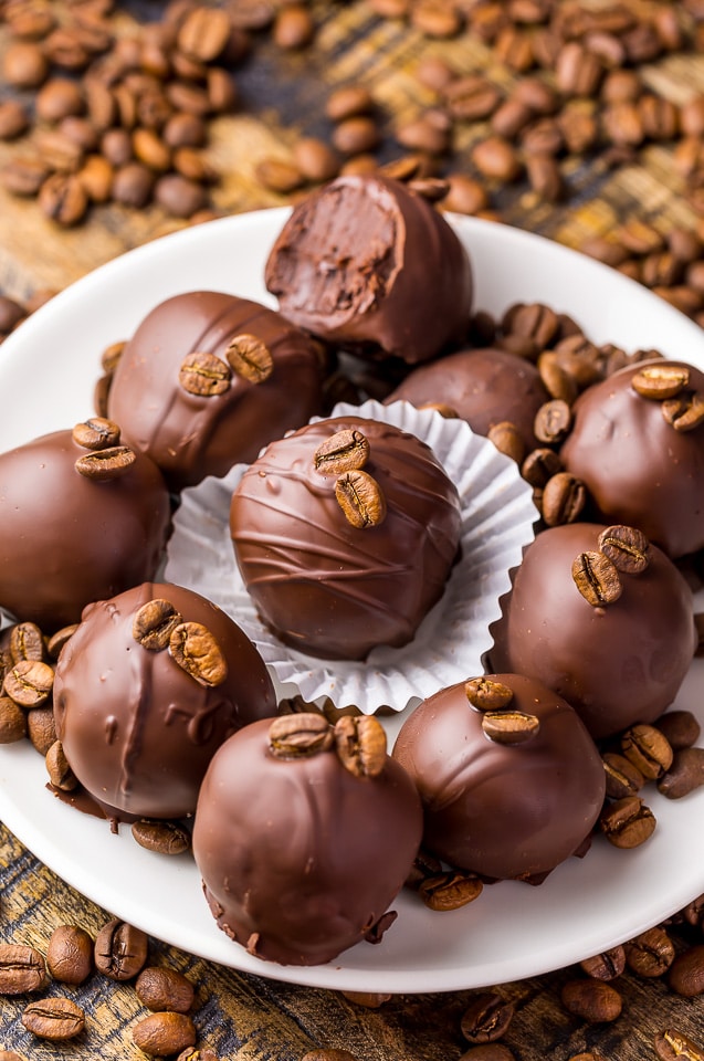 Homemade coffee truffles dipped in chocolate and topped with coffee beans.