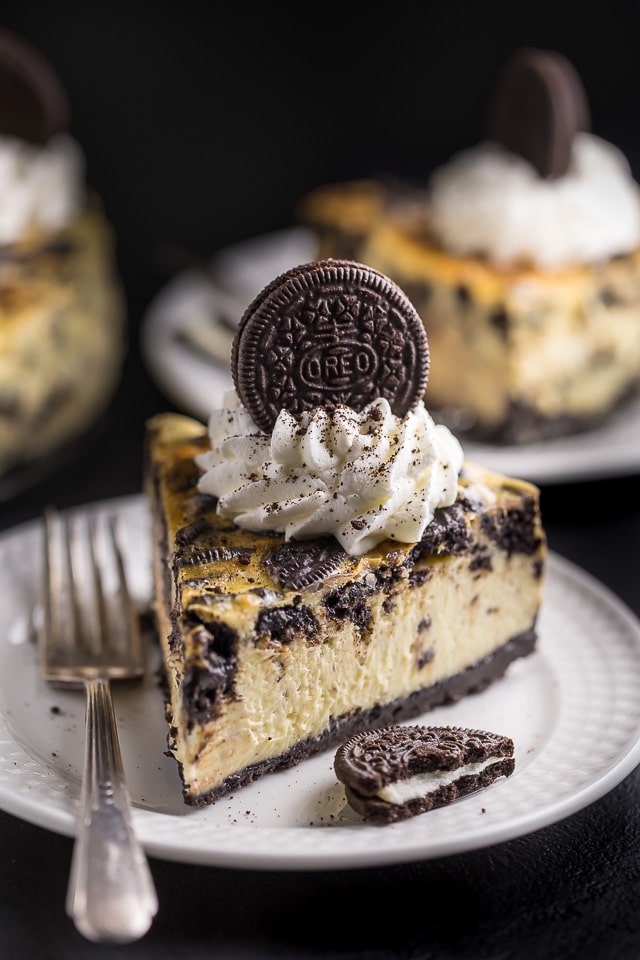Slice of oreo cheesecake on a white plate.