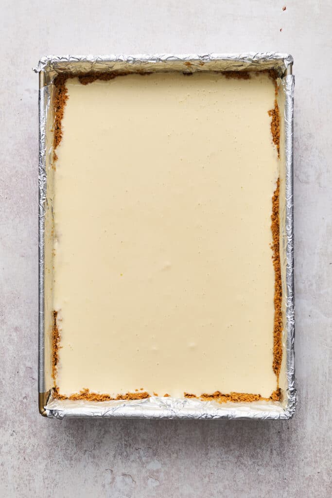 Creamy cheesecake batter in the prepared pan.