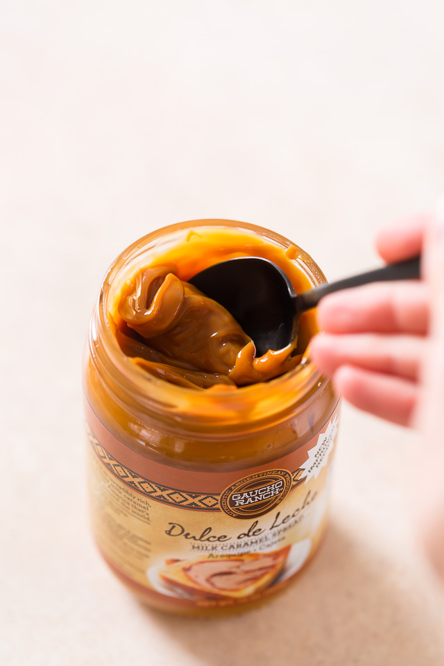 Moist and fluffy Pumpkin Coconut Cupcakes are stuffed with decadent Dulce de Ceche and covered in cinnamon cream cheese frosting! So delicious!