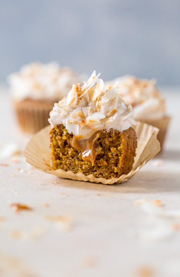 Moist and fluffy Pumpkin Coconut Cupcakes are stuffed with decadent Dulce de Ceche and covered in cinnamon cream cheese frosting! So delicious!