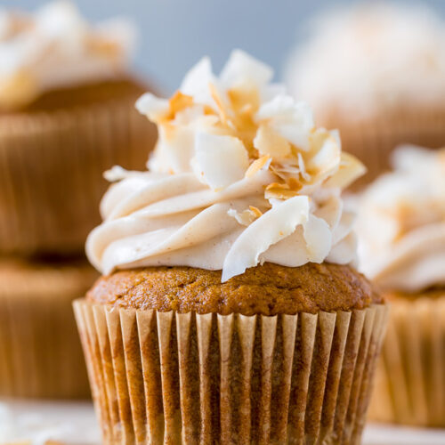 Moist and fluffy Pumpkin Coconut Cupcakes are stuffed with decadent Dulce de Ceche and covered in cinnamon cream cheese frosting! So delicious!