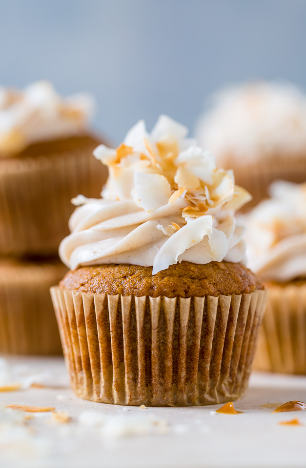 Moist and fluffy Pumpkin Coconut Cupcakes are stuffed with decadent Dulce de Ceche and covered in cinnamon cream cheese frosting! So delicious!