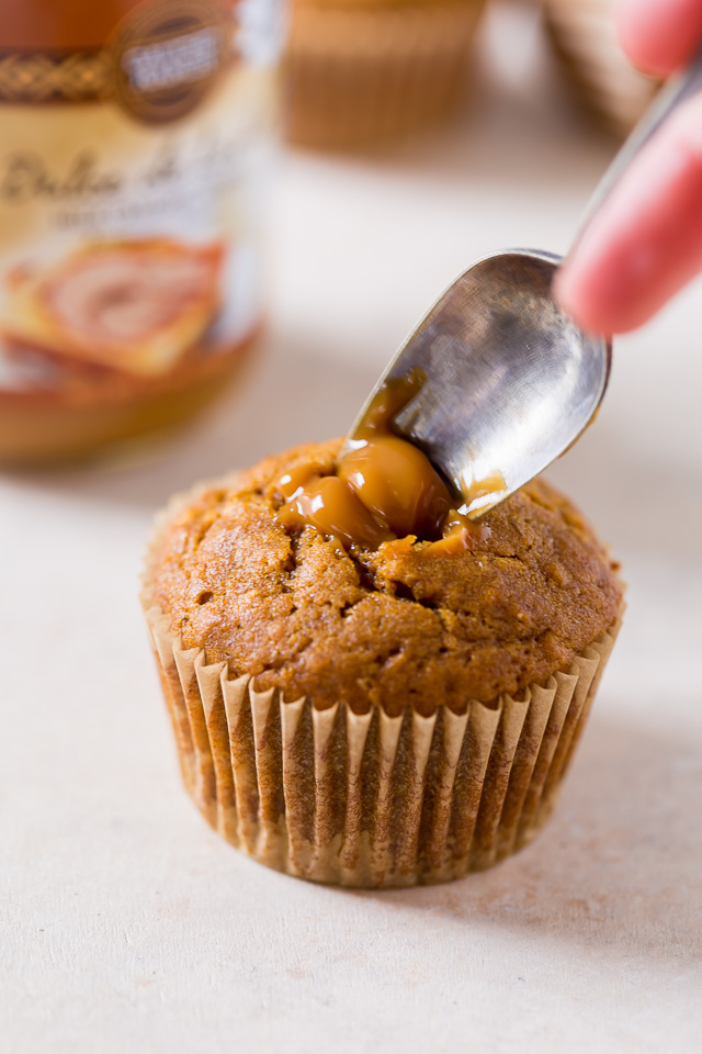 Moist and fluffy Pumpkin Coconut Cupcakes are stuffed with decadent Dulce de Ceche and covered in cinnamon cream cheese frosting! So delicious!