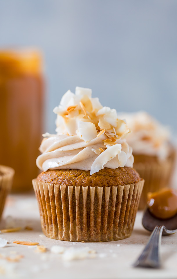 Moist and fluffy Pumpkin Coconut Cupcakes are stuffed with decadent Dulce de Ceche and covered in cinnamon cream cheese frosting! So delicious!