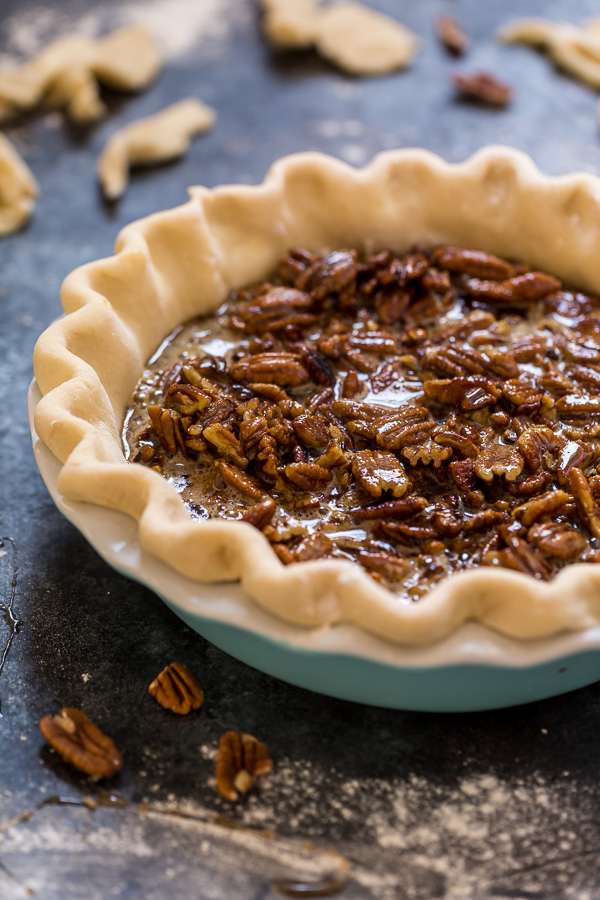 Homemade pie crust filled with pecan pie filling for pecan pie recipe.