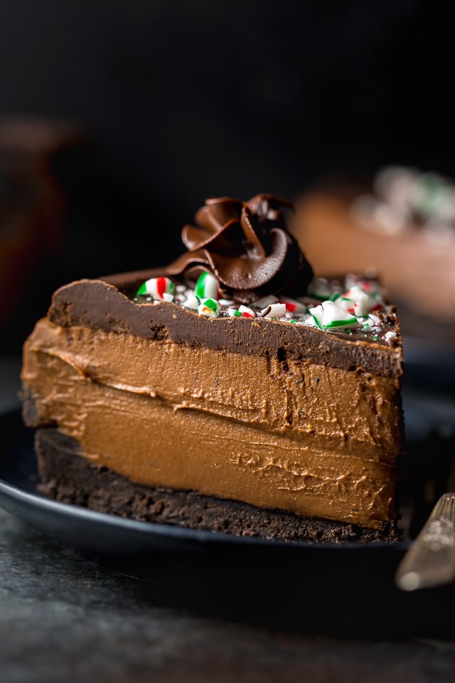 This No-Bake Peppermint Mocha Cheesecake is rich, creamy, and so flavorful! Topped with chocolate ganache and crushed candy canes, this chocolate peppermint cheesecake is seriously festive and perfect for holiday celebrations. #peppermintmocha #cheesecake #chocolate #Christmas #peppermint