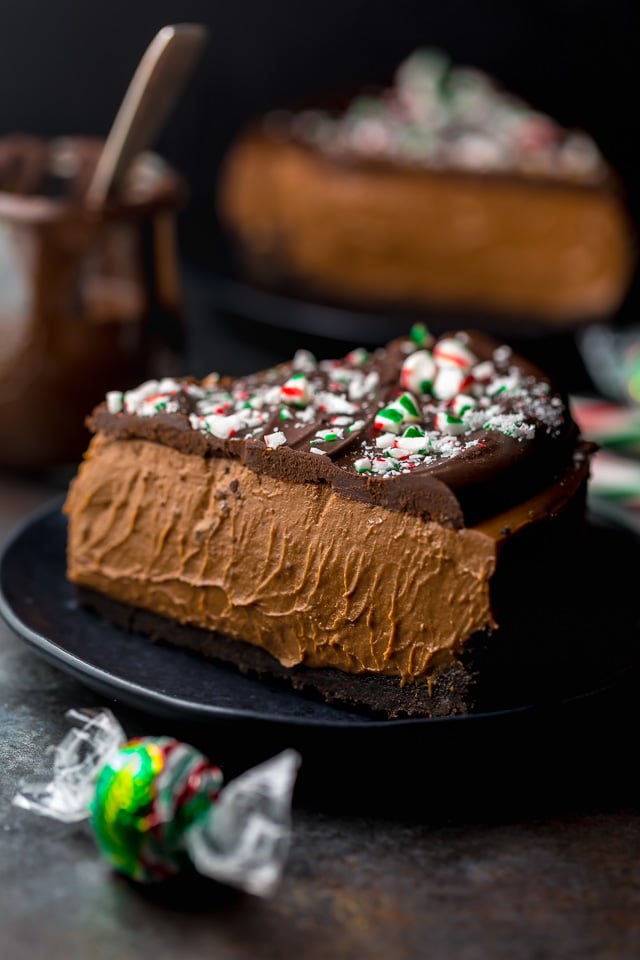 This No-Bake Peppermint Mocha Cheesecake is rich, creamy, and so flavorful! Topped with chocolate ganache and crushed candy canes, this chocolate peppermint cheesecake is seriously festive and perfect for holiday celebrations. #peppermintmocha #cheesecake #chocolate #Christmas #peppermint