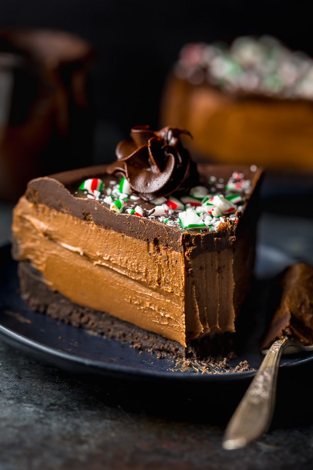 This No-Bake Peppermint Mocha Cheesecake is rich, creamy, and so flavorful! Topped with chocolate ganache and crushed candy canes, this chocolate peppermint cheesecake is seriously festive and perfect for holiday celebrations. #peppermintmocha #cheesecake #chocolate #Christmas #peppermint