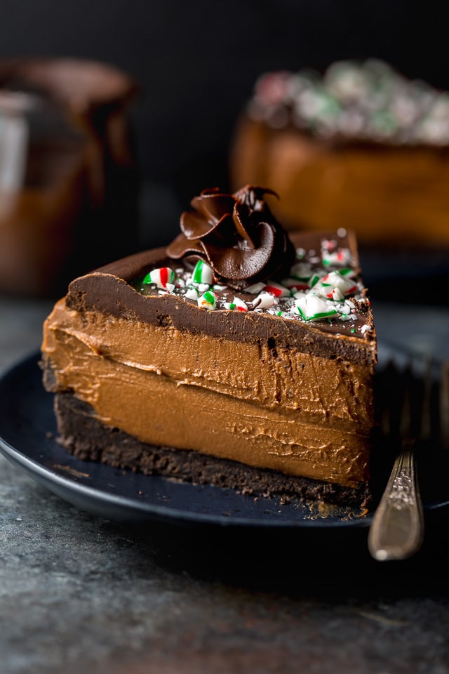 This No-Bake Peppermint Mocha Cheesecake is rich, creamy, and so flavorful! Topped with chocolate ganache and crushed candy canes, this chocolate peppermint cheesecake is seriously festive and perfect for holiday celebrations. #peppermintmocha #cheesecake #chocolate #Christmas #peppermint