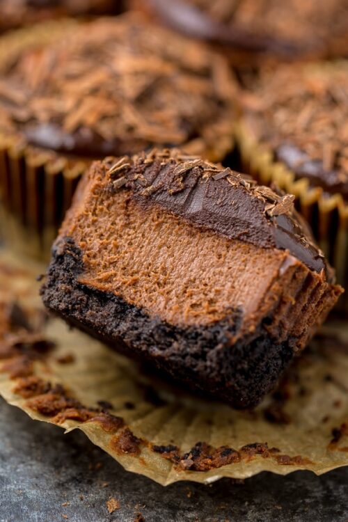 These rich and creamy Mini Chocolate Cheesecakes are made in a muffin pan! So easy and perfect for serving a crowd.