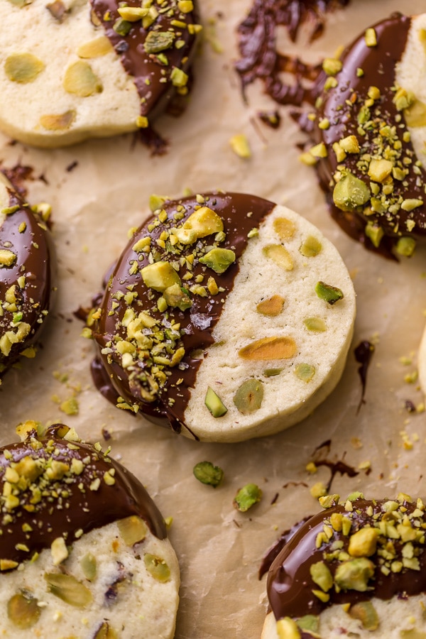 Dark Chocolate Pistachio Slice & Bake Cookies are so easy and made with just 6 ingredients! These buttery shortbread cookies are loaded with pistachios and then dunked in dark chocolate. So good with a cup of coffee or tea!
