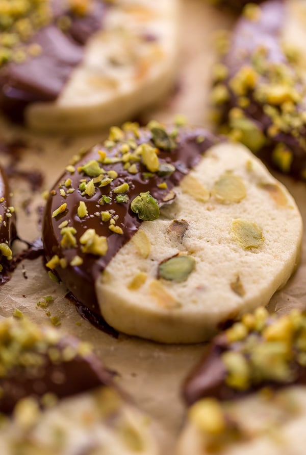 Dark Chocolate Pistachio Slice & Bake Cookies are so easy and made with just 6 ingredients! These buttery shortbread cookies are loaded with pistachios and then dunked in dark chocolate. So good with a cup of coffee or tea!