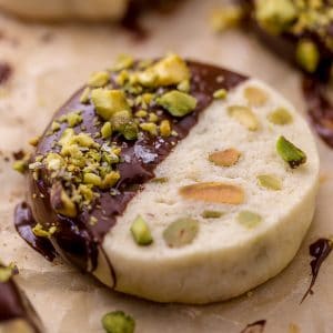 Dark Chocolate Pistachio Slice & Bake Cookies are so easy and made with just 6 ingredients! These buttery shortbread cookies are loaded with pistachios and then dunked in dark chocolate. So good with a cup of coffee or tea!