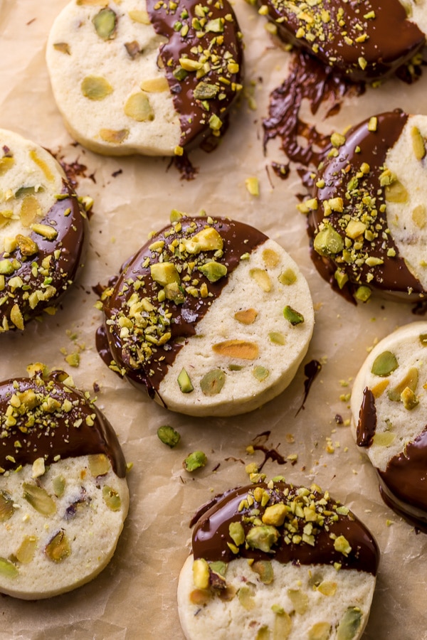 Dark Chocolate Pistachio Slice & Bake Cookies are so easy and made with just 6 ingredients! These buttery shortbread cookies are loaded with pistachios and then dunked in dark chocolate. So good with a cup of coffee or tea!
