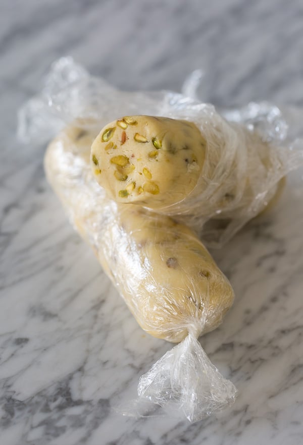 Dark Chocolate Pistachio Slice & Bake Cookies are so easy and made with just 6 ingredients! These buttery shortbread cookies are loaded with pistachios and then dunked in dark chocolate. So good with a cup of coffee or tea!