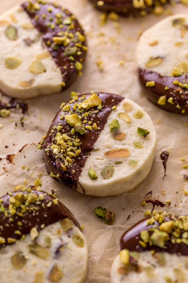Dark Chocolate Pistachio Slice & Bake Cookies are so easy and made with just 6 ingredients! These buttery shortbread cookies are loaded with pistachios and then dunked in dark chocolate. So good with a cup of coffee or tea!