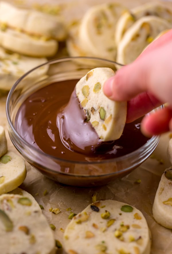 Dark Chocolate Pistachio Slice & Bake Cookies are so easy and made with just 6 ingredients! These buttery shortbread cookies are loaded with pistachios and then dunked in dark chocolate. So good with a cup of coffee or tea!