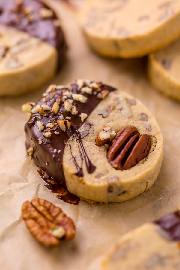 These delicious Butter Pecan Slice and Bake Cookies are so easy and made with just 7 ingredients! These buttery shortbread cookies are loaded with crunchy pecans and then dunked in sweet chocolate. These cookies are so good with a cup of coffee or tea!