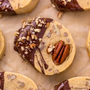 These delicious Butter Pecan Slice and Bake Cookies are so easy and made with just 7 ingredients! These buttery shortbread cookies are loaded with crunchy pecans and then dunked in sweet chocolate. These cookies are so good with a cup of coffee or tea!