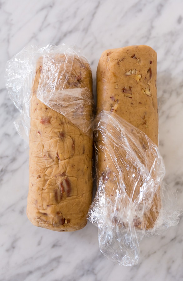 Place the pistachios in a small bowl and cover with water; set aside for 30 minutes. Drain the pistachios well and place them on a paper towel to air dry while you assemble the cookie dough. In the bowl of a stand mixer fitted with the paddle attachment, or in a large bowl using a handheld electric mixer, combine the butter and sugar and beat on medium-high speed until pale and fluffy. Add in the egg and beat until combined. Add in the flour and pistachios and beat until combined. Your dough should be stiff. Sprinkle 2 Tablespoons of flour over a clean work surface. Scrape the cookie dough onto the surface and gently knead it for 30 seconds. Divide the dough in half, then roll each portion of cookie dough into a log that's roughly 2" in diameter. Wrap each log tightly in plastic wrap and refrigerate for at least 2 hours (or up to 5 days). When you're ready to bake, preheat the oven to 350 degrees (F). Line a large baking sheet with parchment paper or a Silpat baking mat. Remove the dough from the fridge and place it on a cutting board. Using a sharp knife, slice the logs of cookie dough into 1/4" rounds. Place the cookies 1/2" apart on the prepared baking sheet, and bake for 10 to 12 minutes, or until lightly golden. Remove the oven and place the pan on a cooling rack. Cool for at least 15 minutes before removing. In the meantime, make the chocolate coating. Melt the chopped chocolate in a double boiler or in the microwave. If using the microwave method, place the chopped chocolate in a medium heat-proof bowl. Melt in the microwave, on low power, in 15 second increments, stirring after each increment until completely melted and smooth. Dip each cookie halfway into the chocolate then return to the lined baking sheet. Sprinkle with sea salt or additional chopped pistachios, if desired. Allow the chocolate to set before serving. To speed this up, place the baking sheet into the refrigerator. Once set, serve and enjoy! These are really good with coffee or tea.
