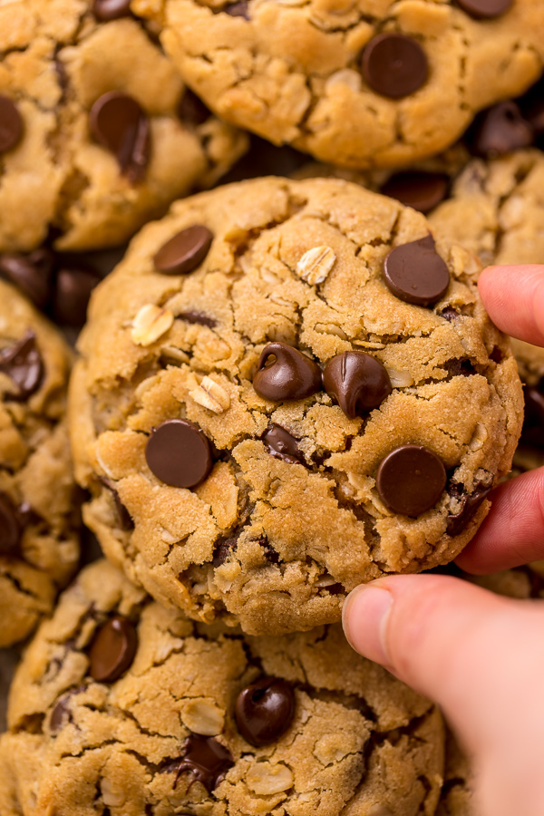 These Peanut Butter Oatmeal Chocolate Chip Cookies are so thick and chewy! Loaded with creamy peanut butter flavor, old-fashioned oats, and chocolate chips, these are a must try for peanut butter lovers! You don't have to chill the cookie dough, which makes this recipe quick and easy to bake.