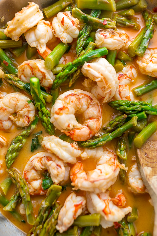 This quick and easy Lemon Garlic Shrimp and Asparagus is ready in less than 20 minutes! This one pan meal is exploding with flavor and always a crowd-pleaser. So next time you're looking for a healthy dinner, give this garlic shrimp and asparagus a try!