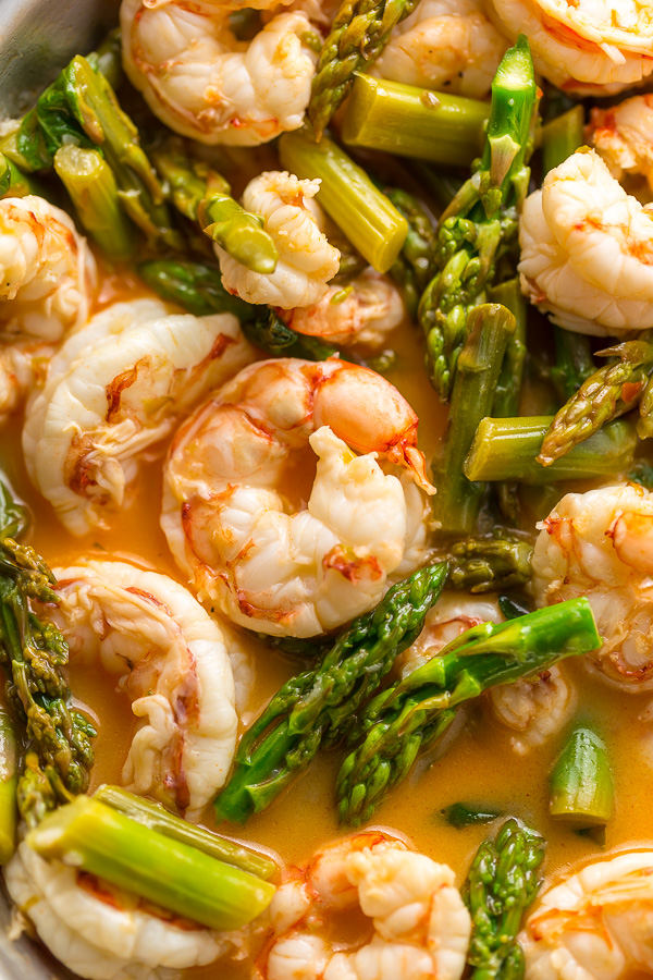This quick and easy Lemon Garlic Shrimp and Asparagus is ready in less than 20 minutes! This one pan meal is exploding with flavor and always a crowd-pleaser. So next time you're looking for a healthy dinner, give this garlic shrimp and asparagus a try!