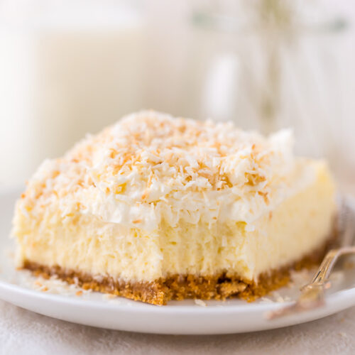 These Coconut Cheesecake Bars are creamy, sweet, and loaded with real coconut in every bite! Baked in cake pan and no water bath required, this recipe is easy and delicious! This family friendly recipe is always a crowd pleaser.