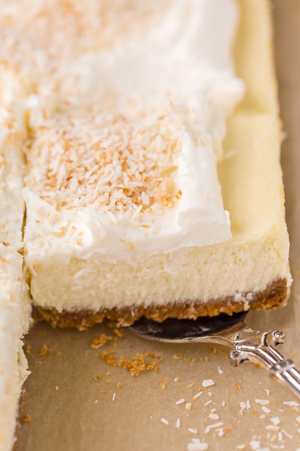 These Coconut Cheesecake Bars are creamy, sweet, and loaded with real coconut in every bite! Baked in cake pan and no water bath required, this recipe is easy and delicious! This family friendly recipe is always a crowd pleaser.
