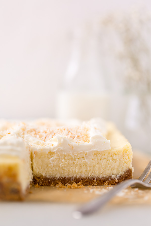 These Coconut Cheesecake Bars are creamy, sweet, and loaded with real coconut in every bite! Baked in cake pan and no water bath required, this recipe is easy and delicious! This family friendly recipe is always a crowd pleaser.