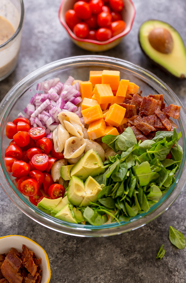This Creamy Avocado BLT Pasta Salad is so easy and perfect for Summer celebrations! Loaded with crispy bacon, juicy tomatoes, spinach, avocado, and cheddar cheese. This flavorful pasta salad is always a crowd-pleaser!