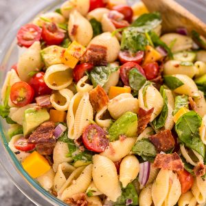 This Creamy Avocado BLT Pasta Salad is so easy and perfect for Summer celebrations! Loaded with crispy bacon, juicy tomatoes, spinach, avocado, and cheddar cheese. This flavorful pasta salad is always a crowd-pleaser!