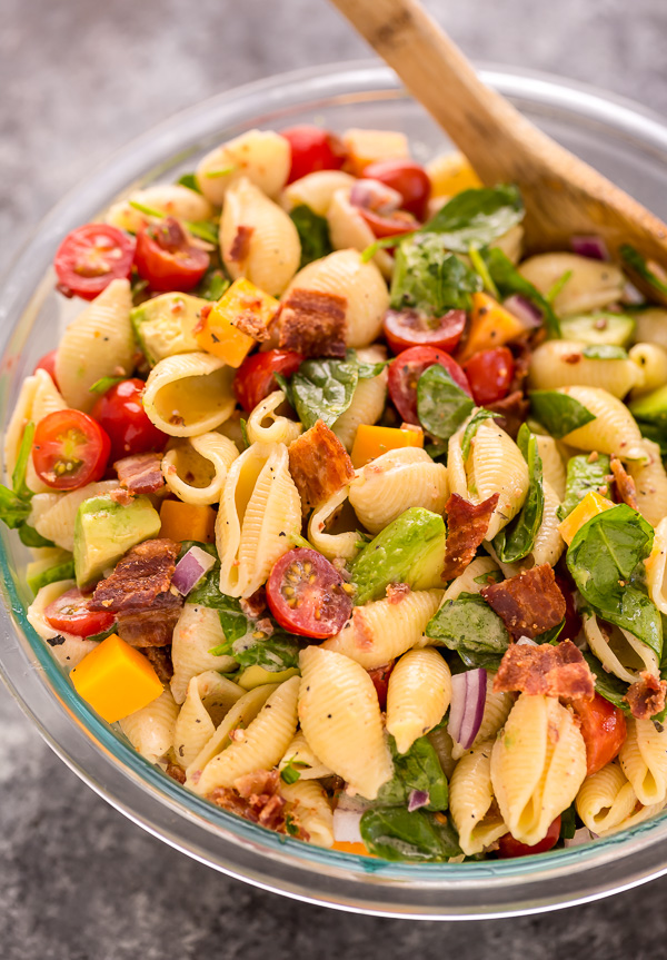 This Creamy Avocado BLT Pasta Salad is so easy and perfect for Summer celebrations! Loaded with crispy bacon, juicy tomatoes, spinach, avocado, and cheddar cheese. This flavorful pasta salad is always a crowd-pleaser!