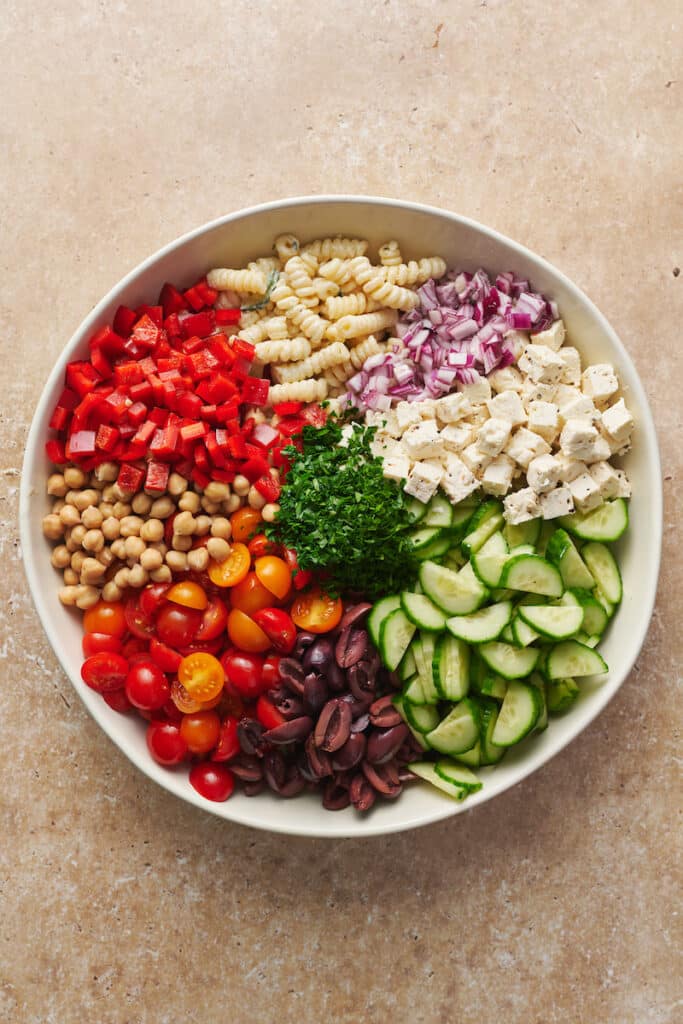 Greek salad ingredients in a large bowl.