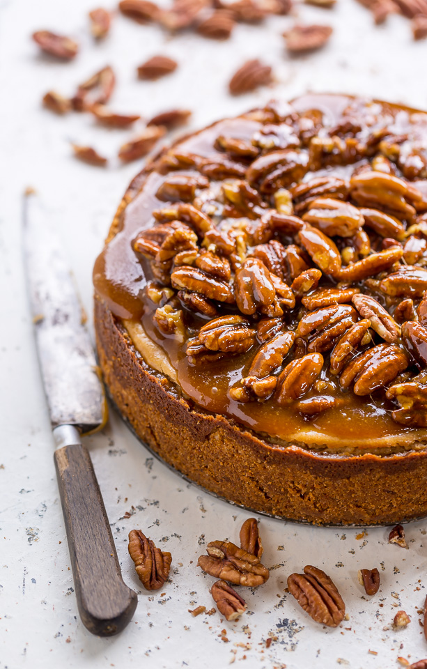Pecan pie cheesecake on cutting board with knife.