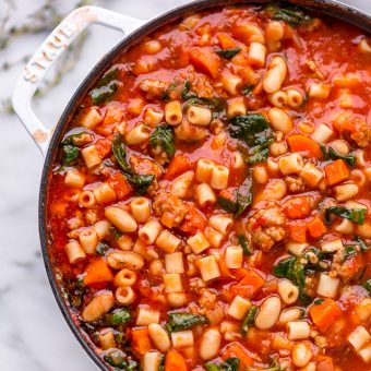 Large pot of Pasta Fagioli Soup on marble table.