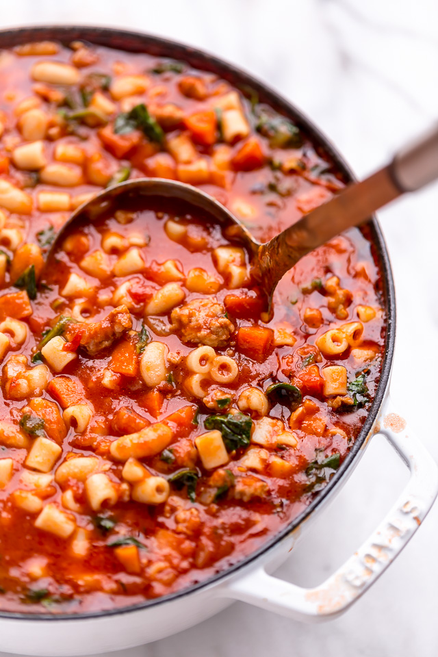 Large pot of pasta fagioli soup with ladle.