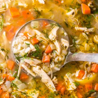 Dutch oven with chicken and rice soup in it.