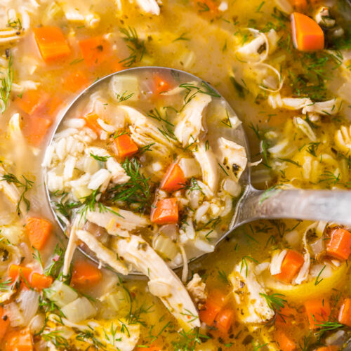 Dutch oven with chicken and rice soup in it.