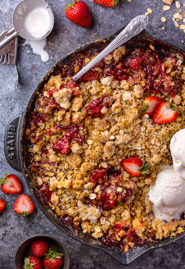 This Easy Strawberry Crisp is the perfect Summer dessert! Featuring plenty of juicy strawberries and a golden brown oatmeal crisp topping, it's best served warm... with a big scoop of vanilla ice cream on top! Can be made with fresh or frozen strawberries!