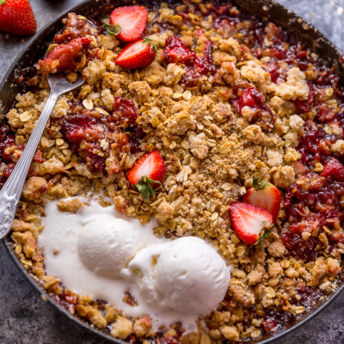 This Easy Strawberry Crisp is the perfect Summer dessert! Featuring plenty of juicy strawberries and a golden brown oatmeal crisp topping, it's best served warm... with a big scoop of vanilla ice cream on top! Can be made with fresh or frozen strawberries!