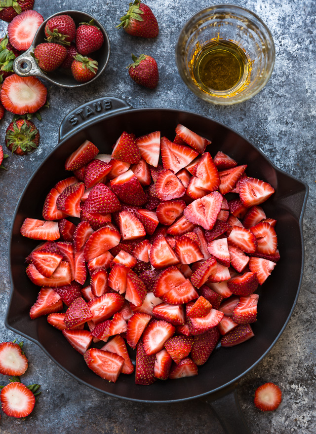 This Easy Strawberry Crisp is the perfect Summer dessert! Featuring plenty of juicy strawberries and a golden brown oatmeal crisp topping, it's best served warm... with a big scoop of vanilla ice cream on top! Can be made with fresh or frozen strawberries!