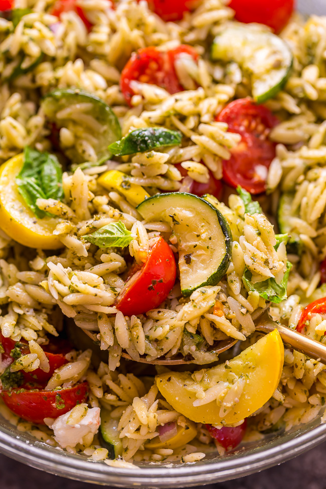It's beginning to feel a lot like Summer, and you know what that means, right? It's PASTA SALAD SEASON! And this Pesto Orzo Pasta Salad with Zucchini, Goat Cheese, and Tomatoes is sure to be on heavy rotation all Summer long! This mayo-free pasta salad is vegetarian friendly and perfect for picnics, potlucks, and barbecues! #pestopastasalad #pesto #orzo #orzopastasalad