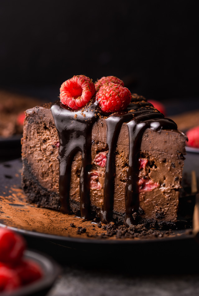 This Dark Chocolate Raspberry Cheesecake is pure decadence! It's not too sweet and but very rich, so a small slice goes far! The fresh raspberry pockets swirled throughout are delightfully refreshing! #chocolateraspberrycheesecake #chocolate #raspberry #raspberrycheesecake #cheesecake #Chocolatecheesecake #dessertrecipes