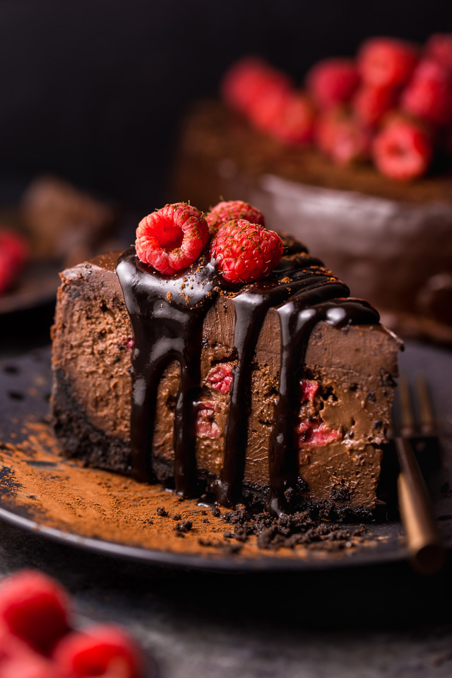 This Dark Chocolate Raspberry Cheesecake is pure decadence! It's not too sweet and but very rich, so a small slice goes far! The fresh raspberry pockets swirled throughout are delightfully refreshing! #chocolateraspberrycheesecake #chocolate #raspberry #raspberrycheesecake #cheesecake #Chocolatecheesecake #dessertrecipes
