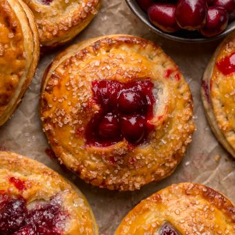 Rustic Cranberry Hand Pies feature a flaky crust and a delicious orange cranberry filling! And their petite handheld size makes them perfect for sharing this holiday season! It's just not Christmas in our house without these on the table!