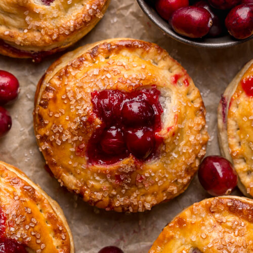 Rustic Cranberry Hand Pies feature a flaky crust and a delicious orange cranberry filling! And their petite handheld size makes them perfect for sharing this holiday season! It's just not Christmas in our house without these on the table!