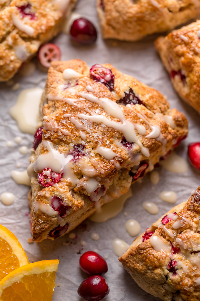 Cranberry orange scones on parchment paper.