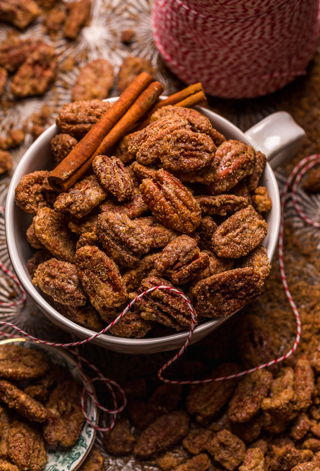 Candied pecans in a serving bowl with holiday ribbon.
